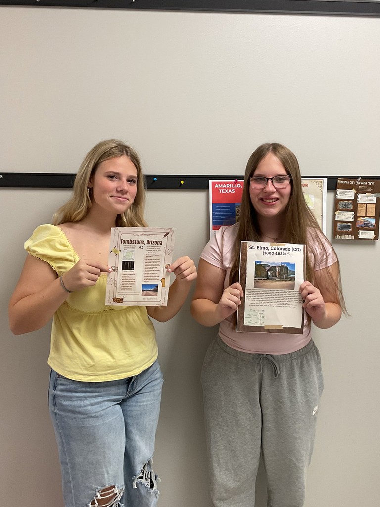 students holding folders