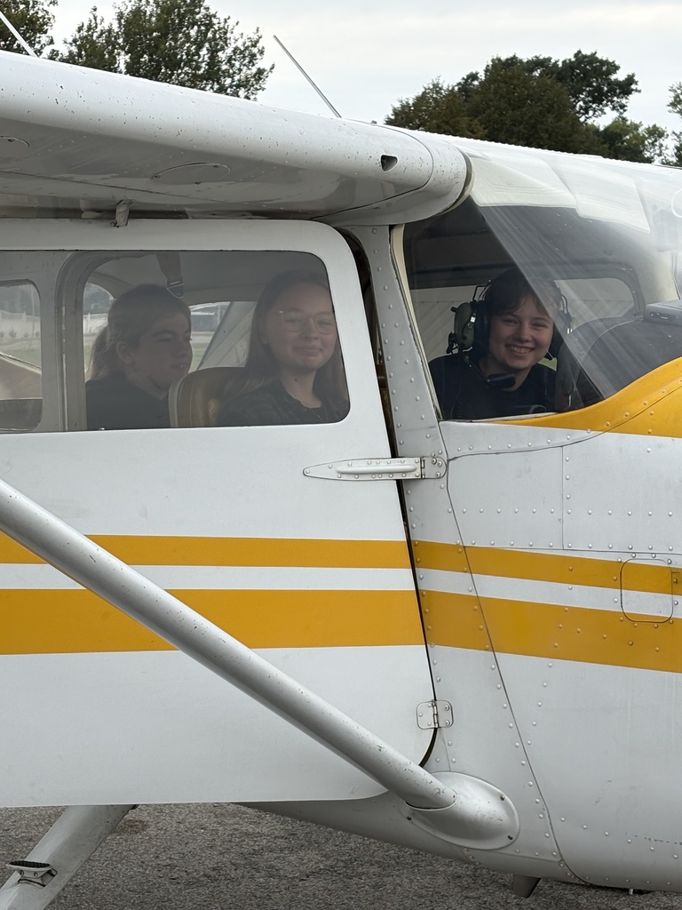 3 students sitting in airplane