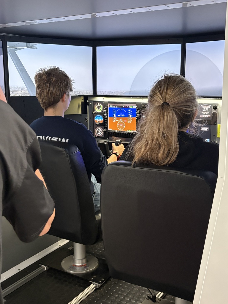 2 students in flight simulator