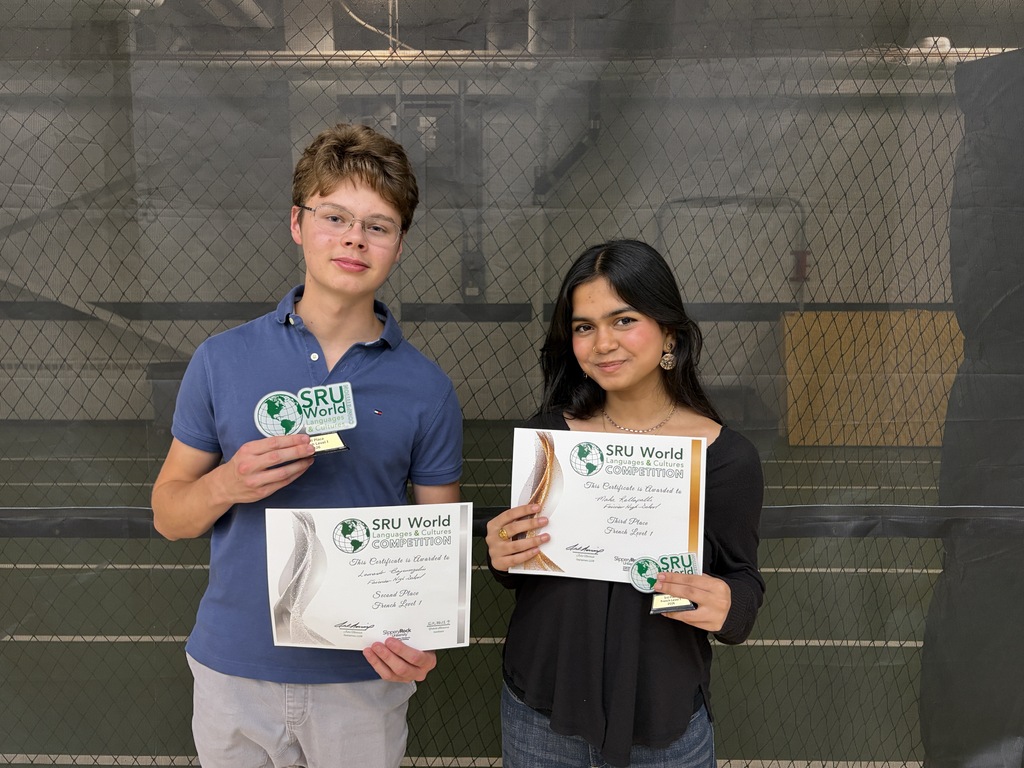 2 students holding awards