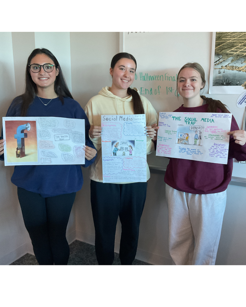 3 students holding posters