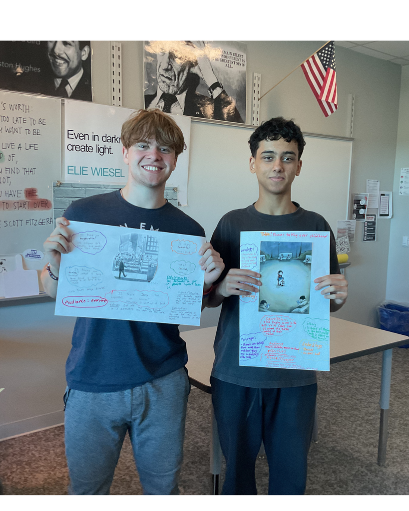 2 students holding posters