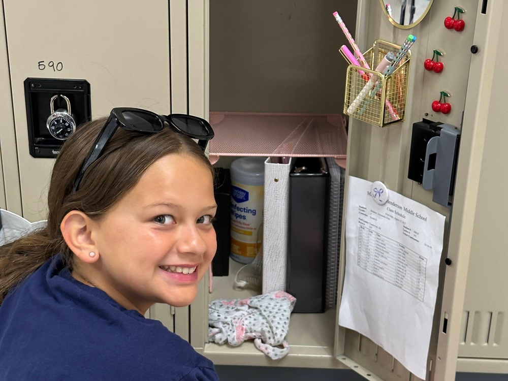 Student smiles while decorating her locker