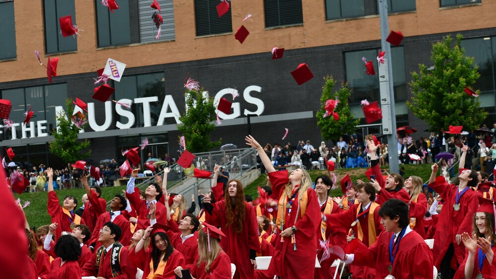 Meridian Seniors toss their graduation hats into the air after being proclaimed, "Graduates"