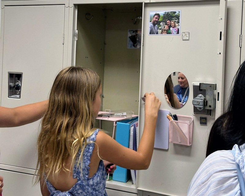 Female student decorating her locker