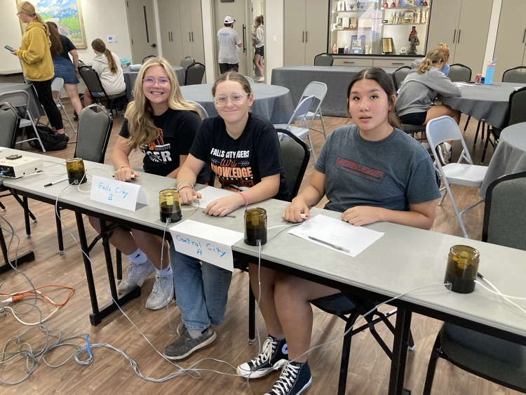 three high school quiz bowl students competing