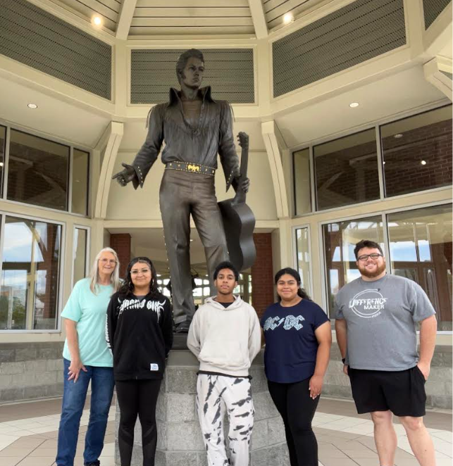 BETA staff and students in front of Elvis statue