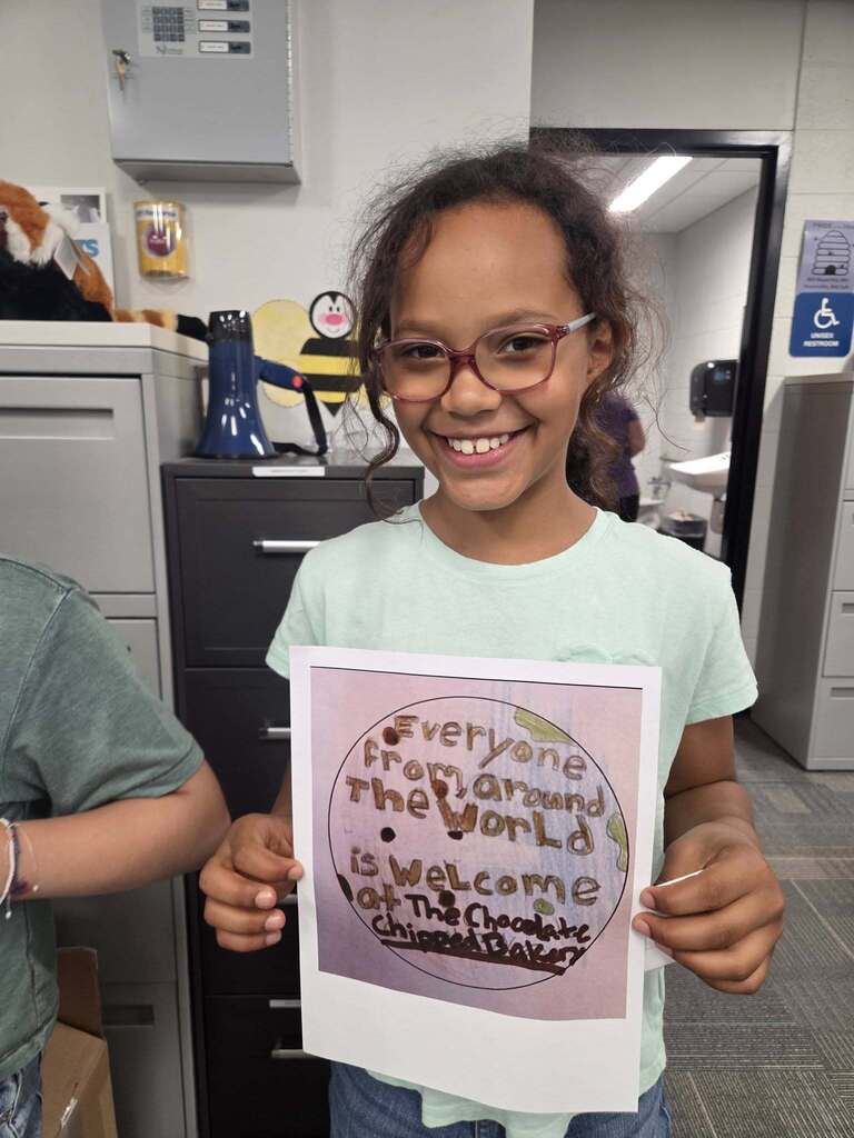 Student holding up her artwork.