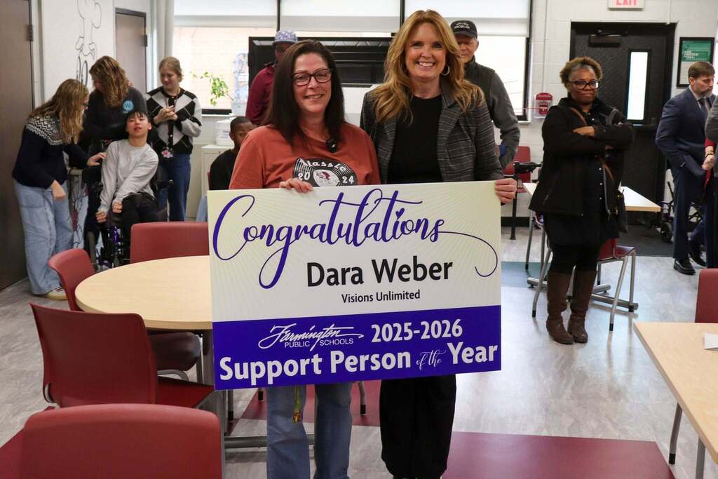 Photo of two women, Dara Weber and Superintendent Dr. Kelly Coffin, holding a Support Person of the Year Sign and smiling at the camera