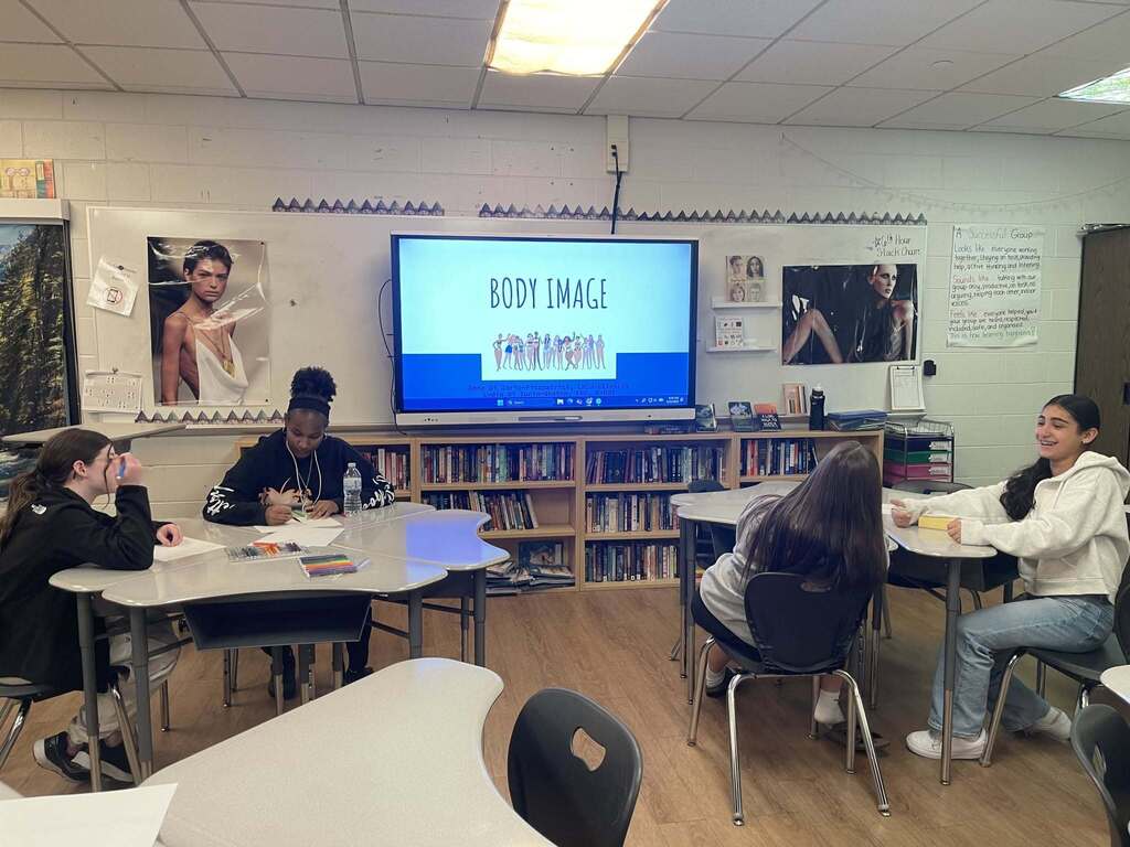 Students looking at a presentation about body image 