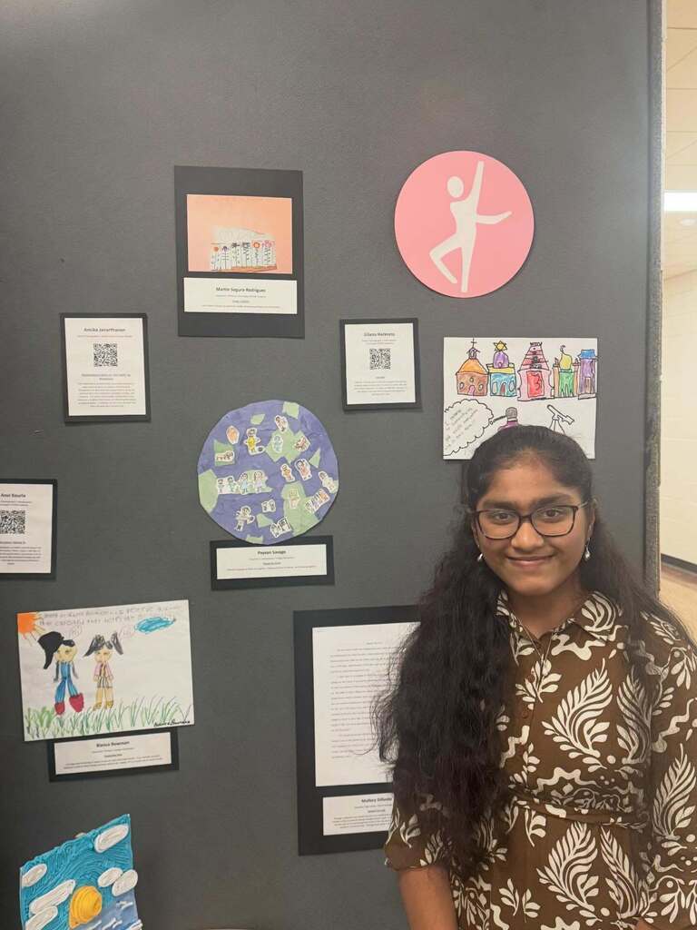 Student standing next to art.