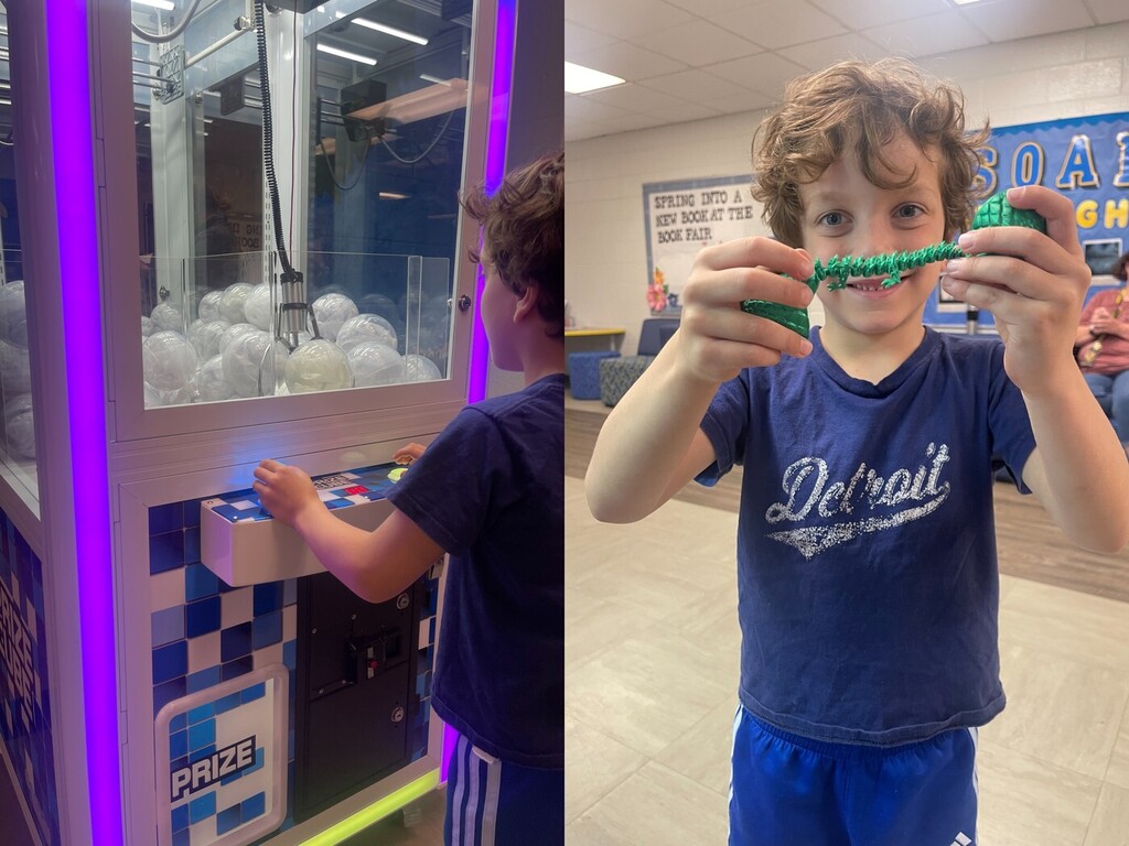 A student working the claw machine and then seeing his prize come out