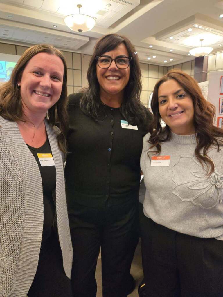 Three educators smiling for the camera