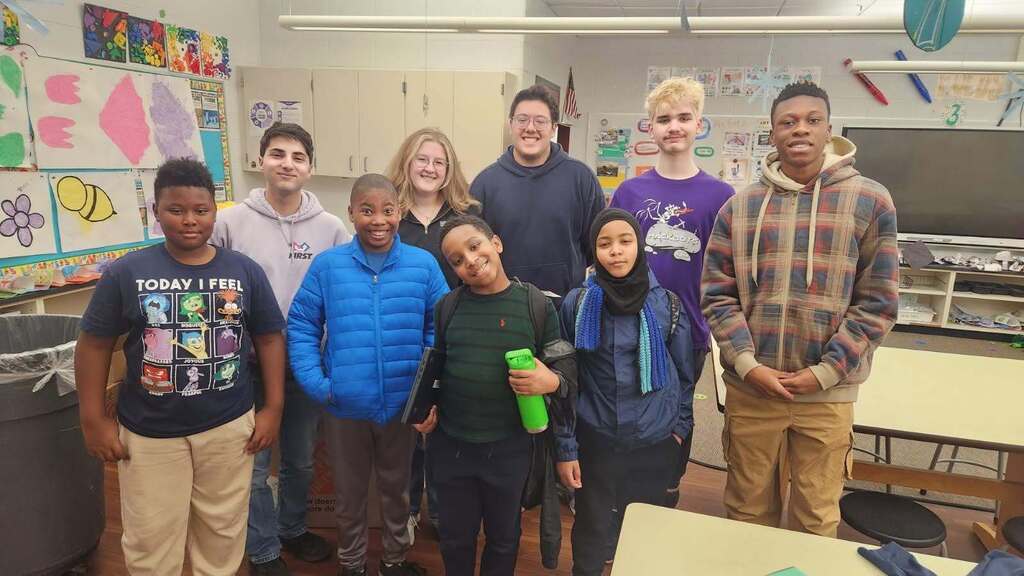 Group of students and Hackbots members smiling