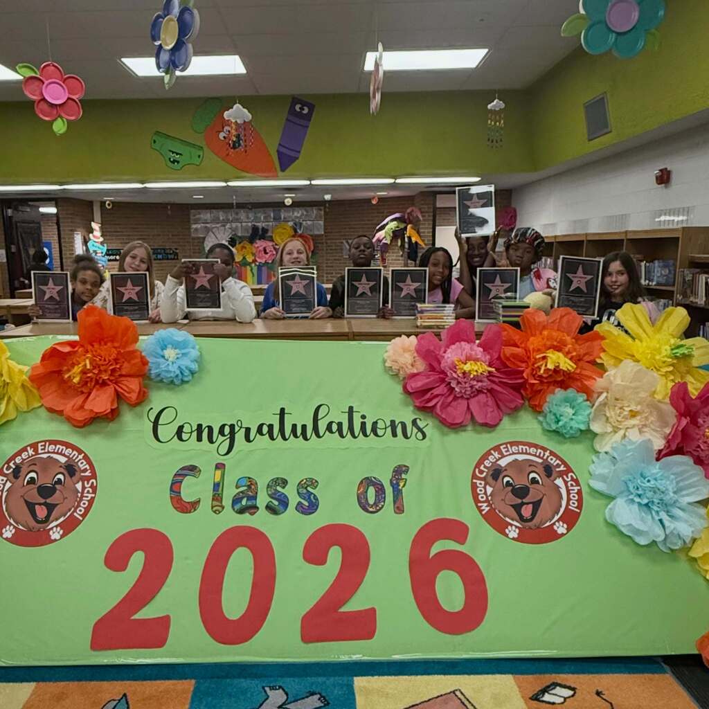 Students with star awards stand behind a Class of 2026 sign.