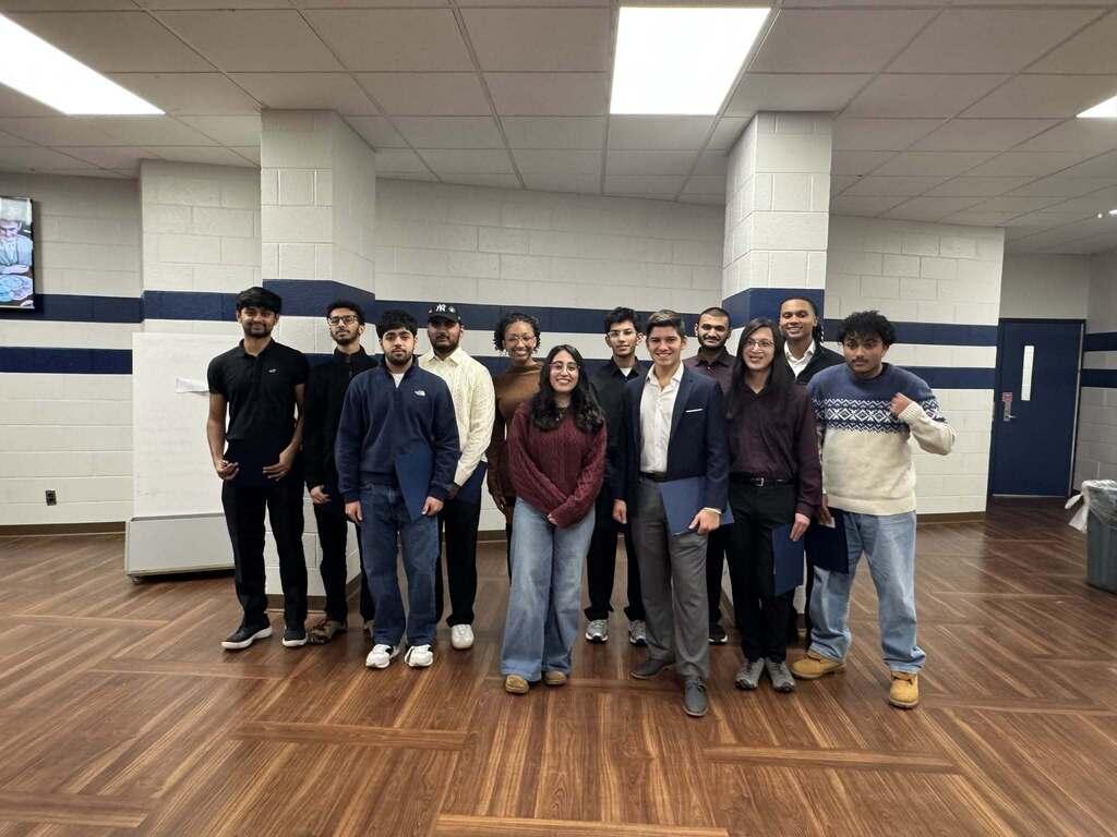 Photo of the IB graduates standing together and smiling. 