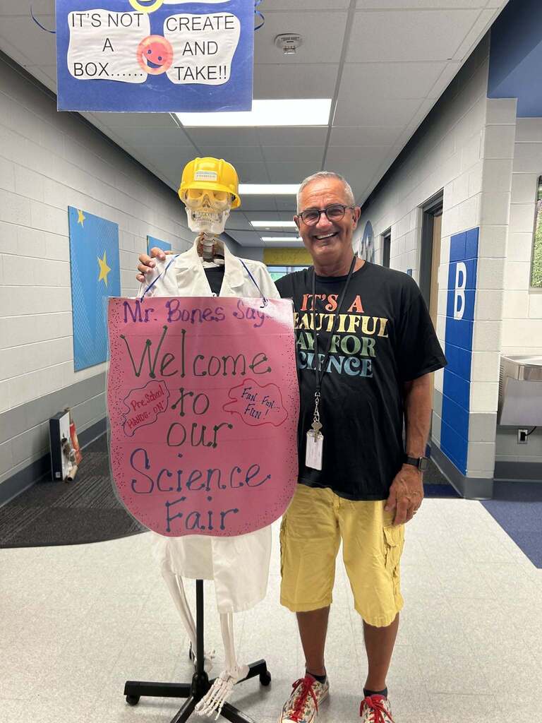 FECC Staff member welcoming families to the Science Fair.