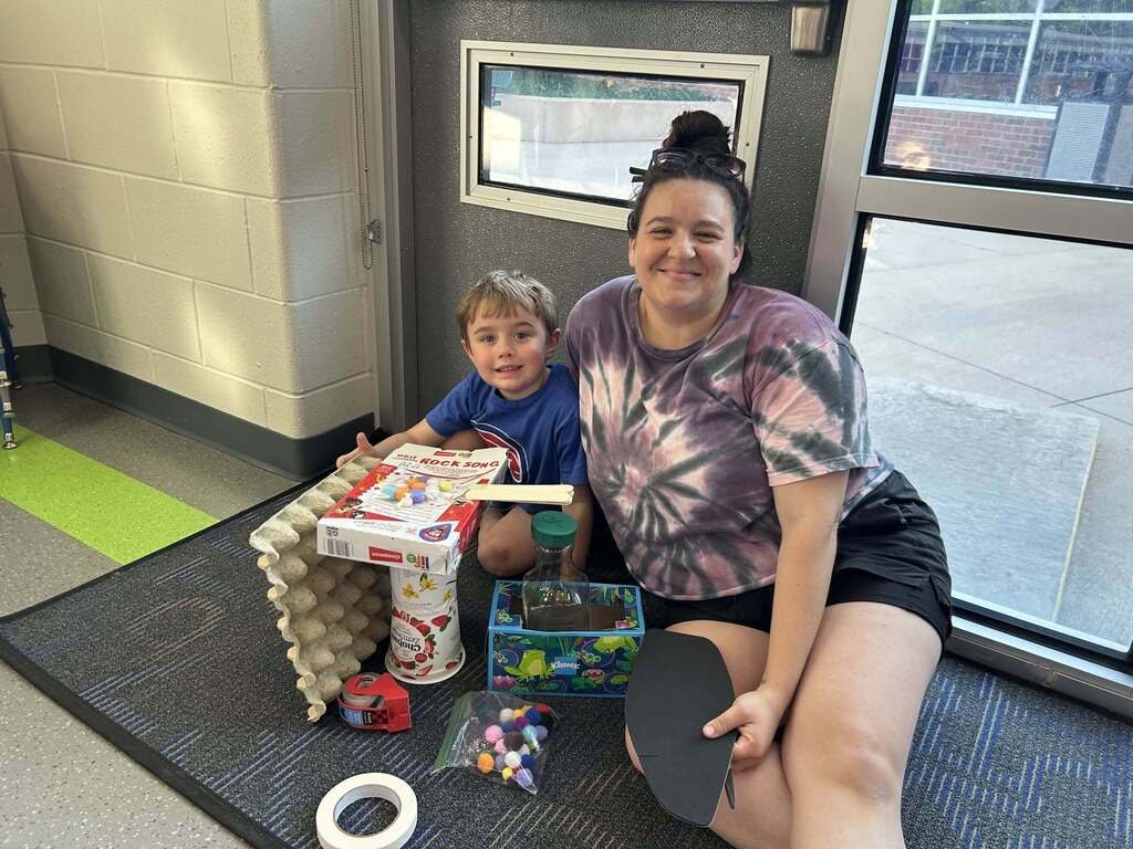 FECC Student and family member with his Science Fair project.