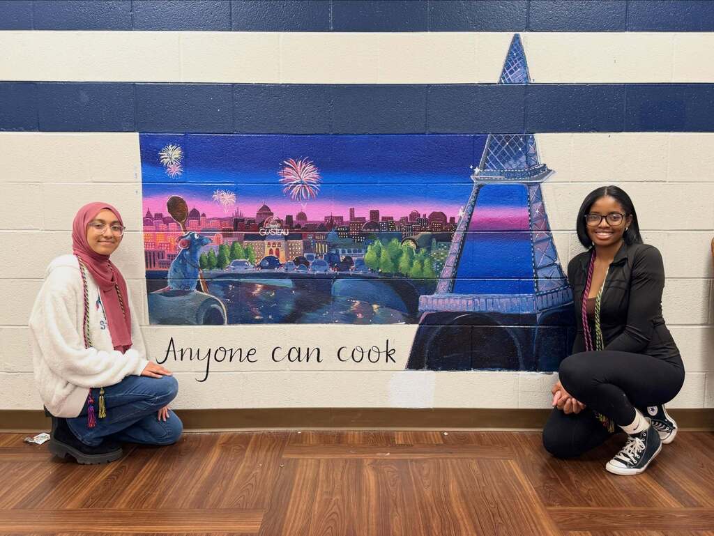FHS students posing in front of their mural done for NAHS.