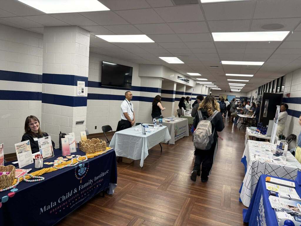 Students walking through booths set up in the hall during FHS' Mental Health Resource Fair.