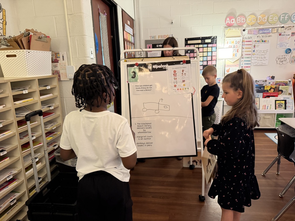 a young boy and girl looking at an image of a car on a whiteboard about how children get books delivered to them