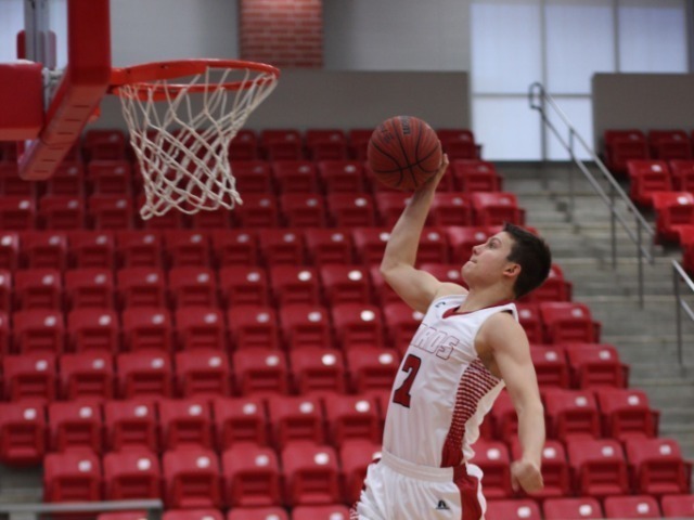 Student dunking basketball