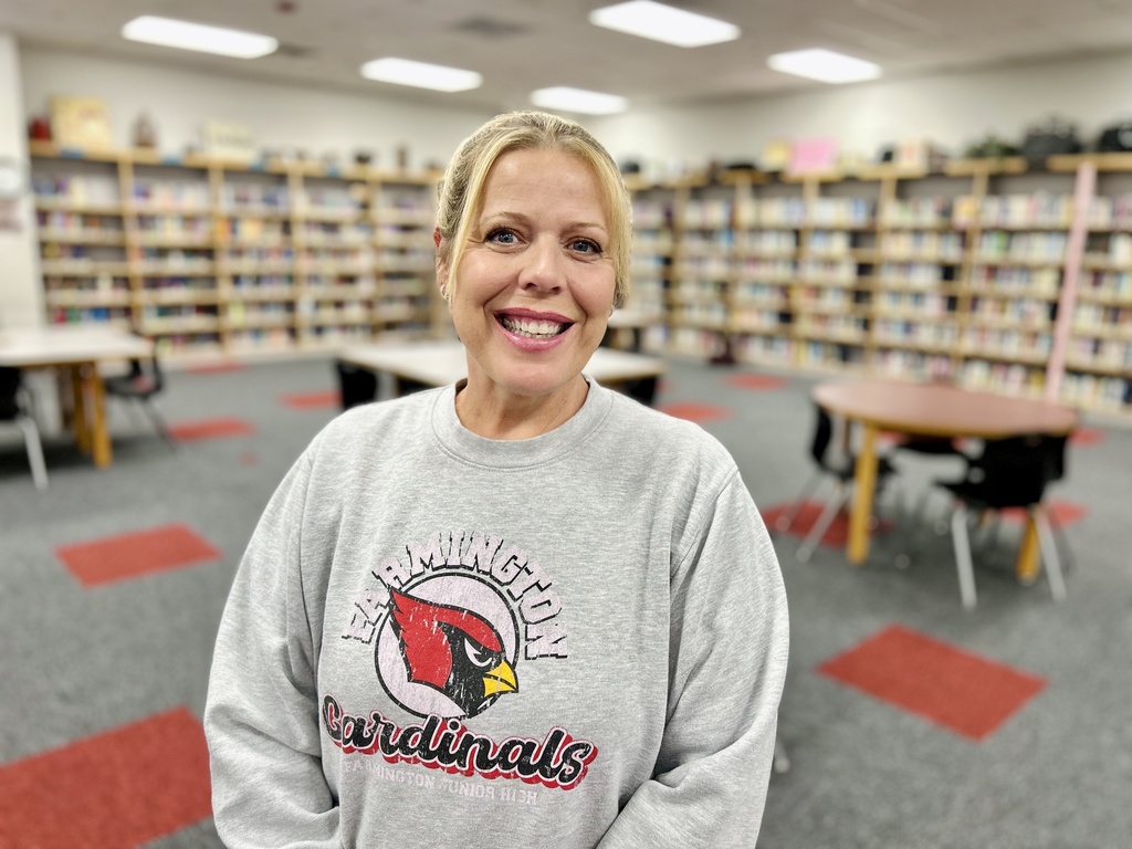 Mrs. Berger smiling for camera in the library