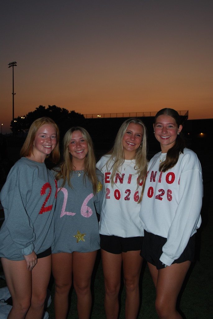 students posing on football field