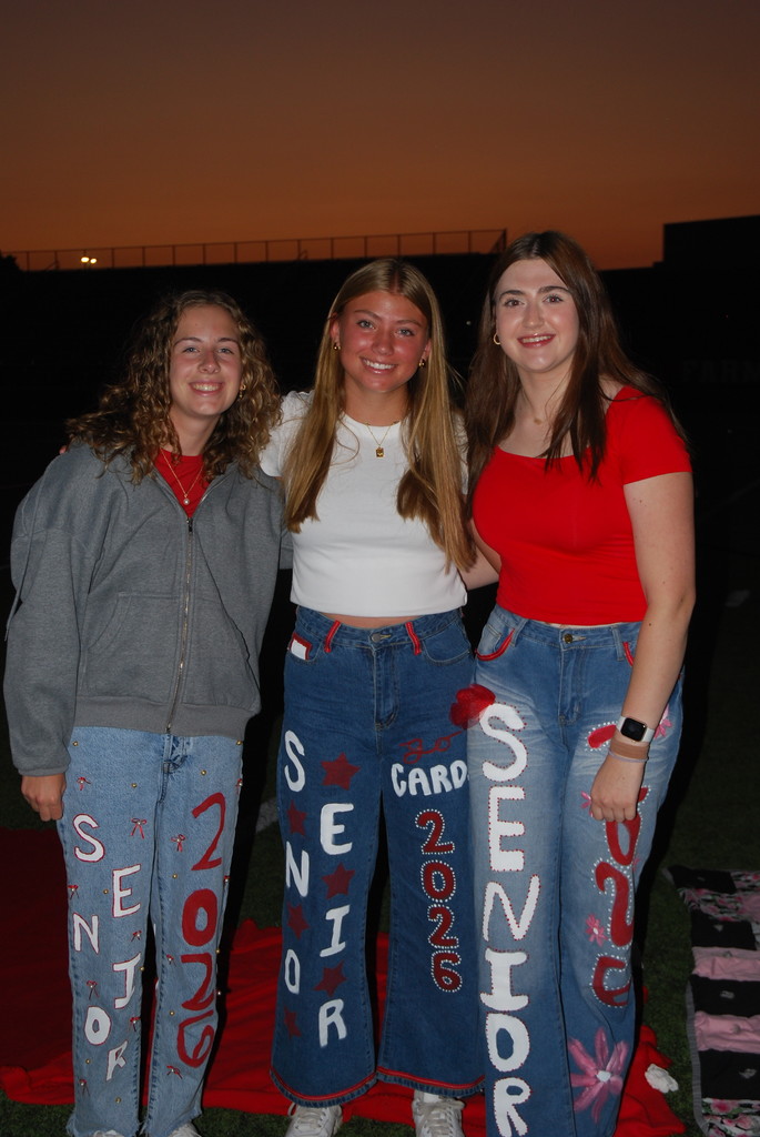 students posing on football field
