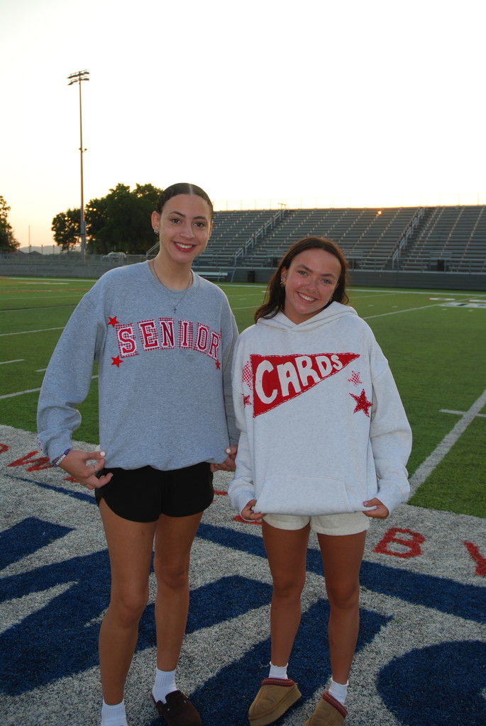 students posing on football field
