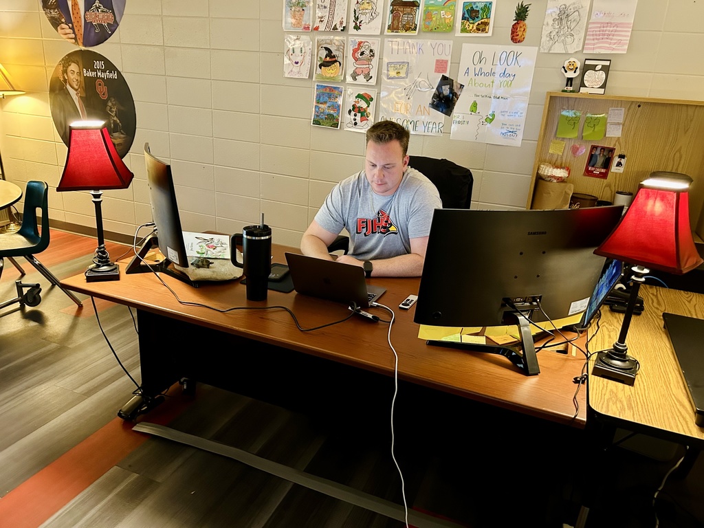 Teacher sitting behind desk