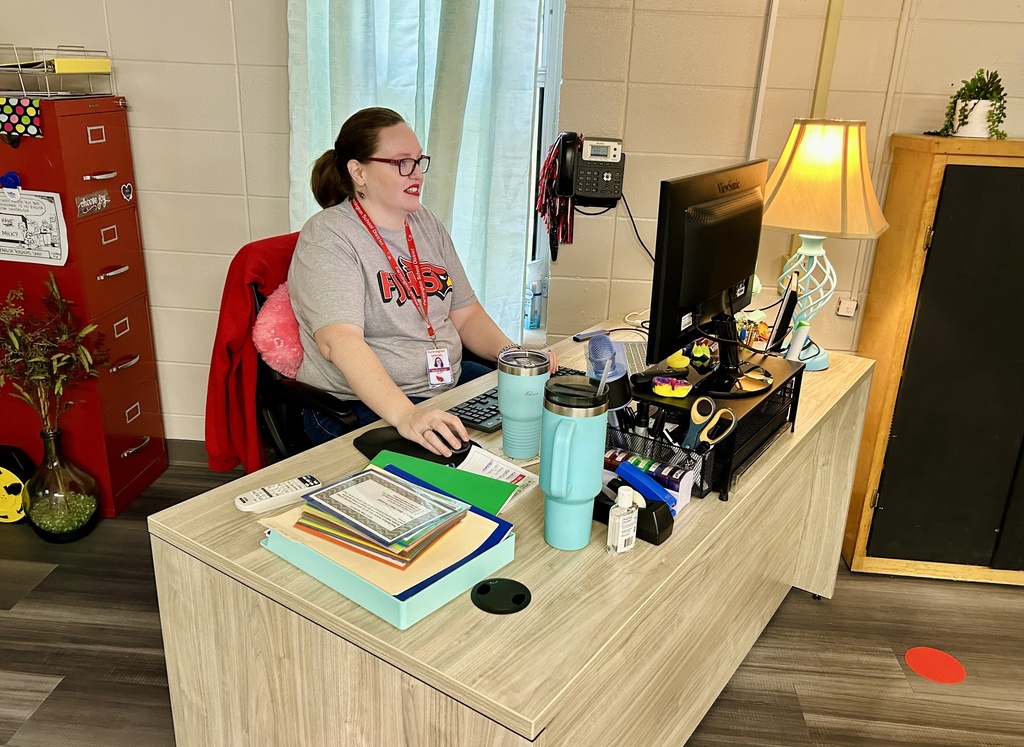Teacher sitting behind desk