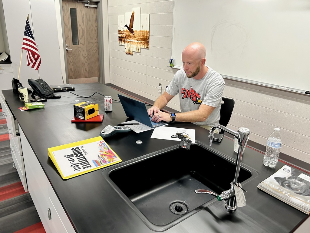 Teacher sitting behind desk