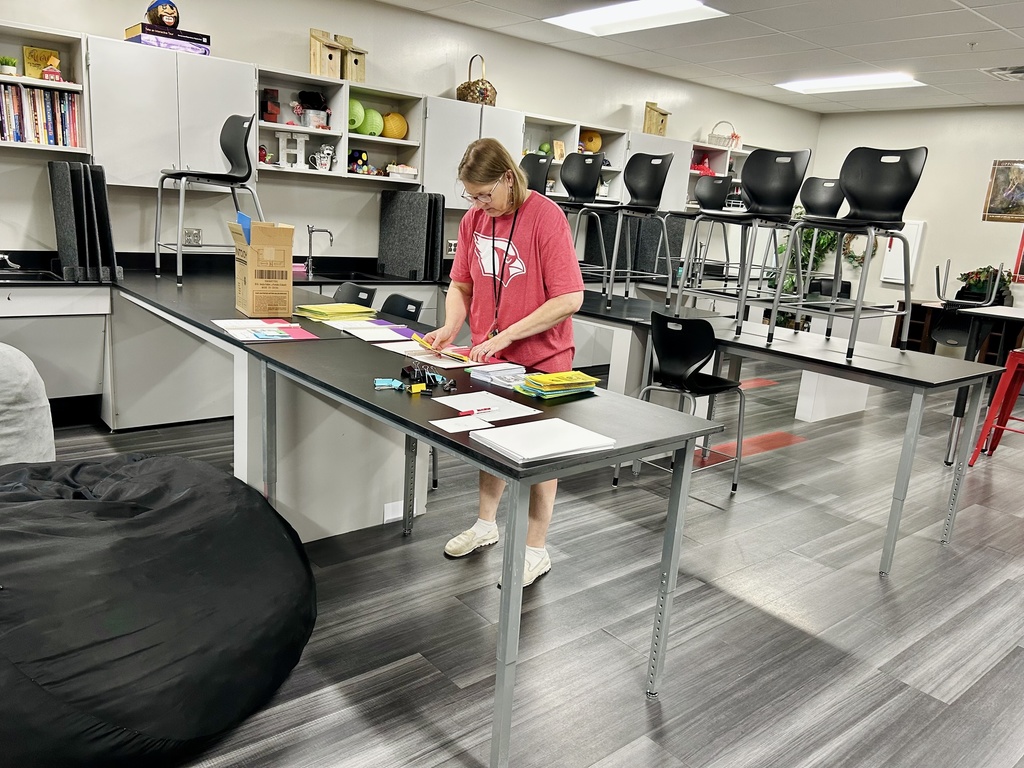 Teacher standing behind desk