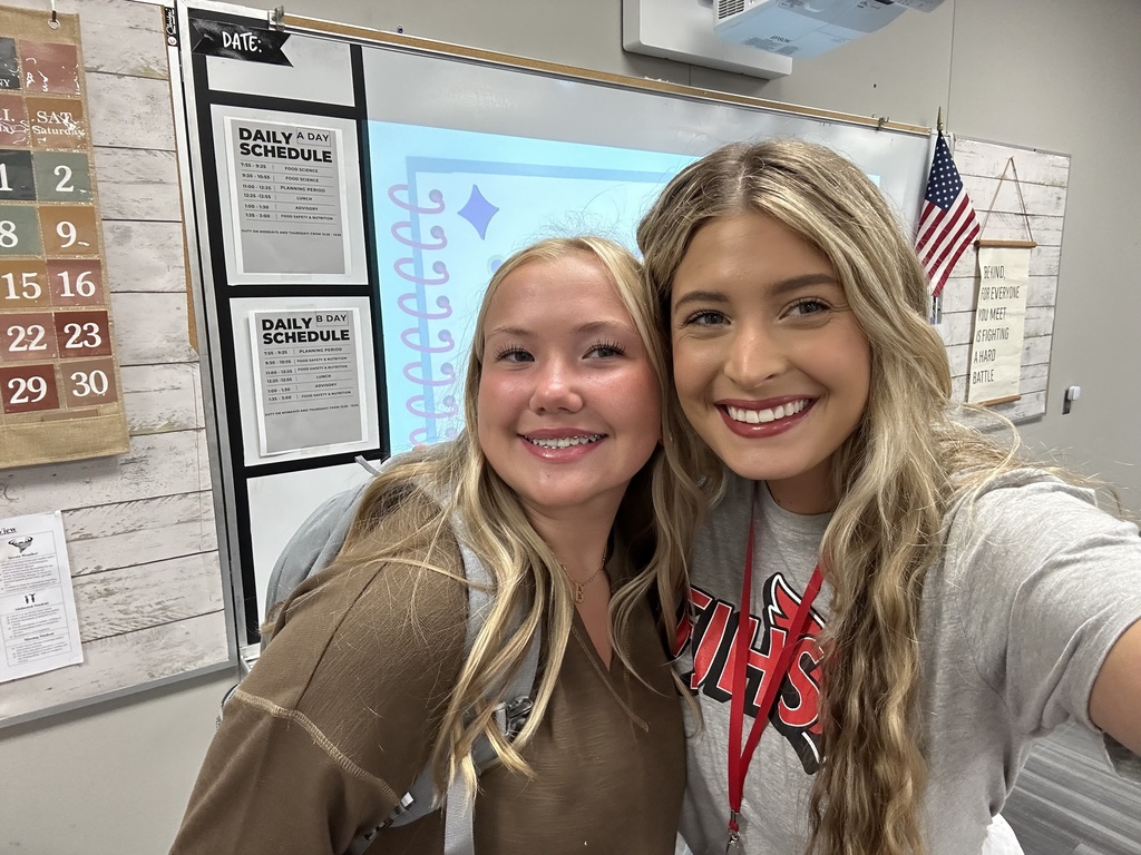 Teacher and student smiling