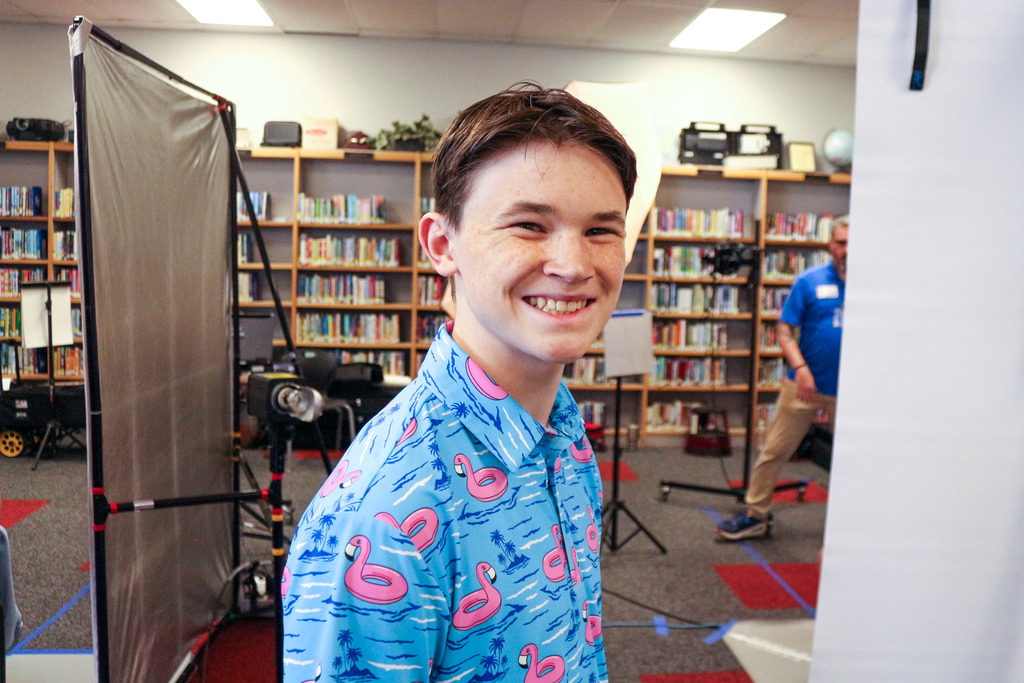 Students smiling for the camera before getting yearbook photo