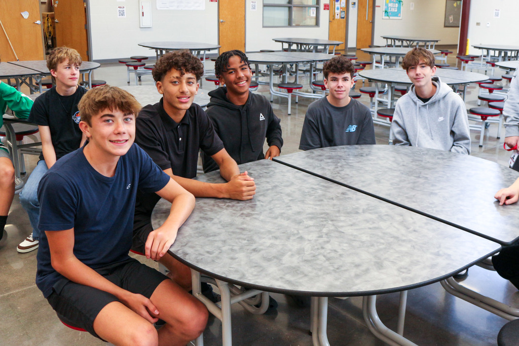 Students sitting at tables in commons