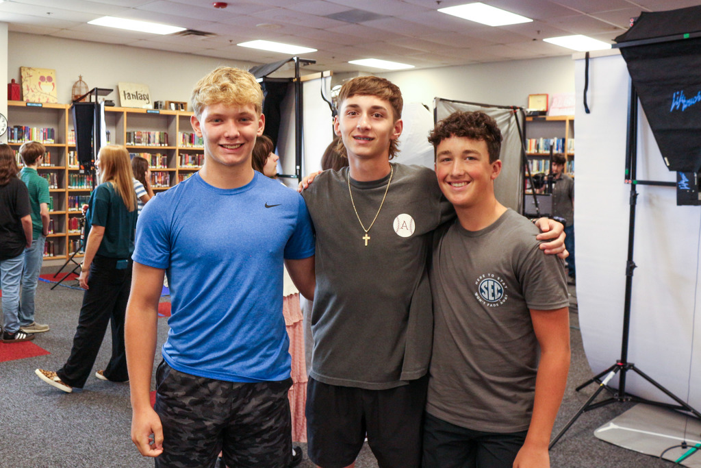 3 students waiting to get yearbook photo taken