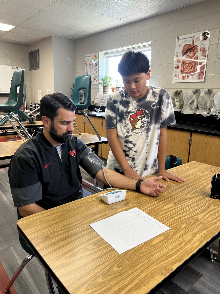 Mr. Pair getting his blood pressure reading from a student
