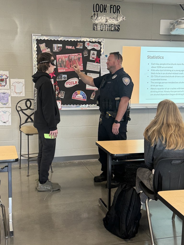 students wearing goggles in class while doing a field sobriety test
