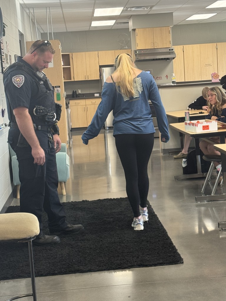 students wearing goggles in class while doing a field sobriety test
