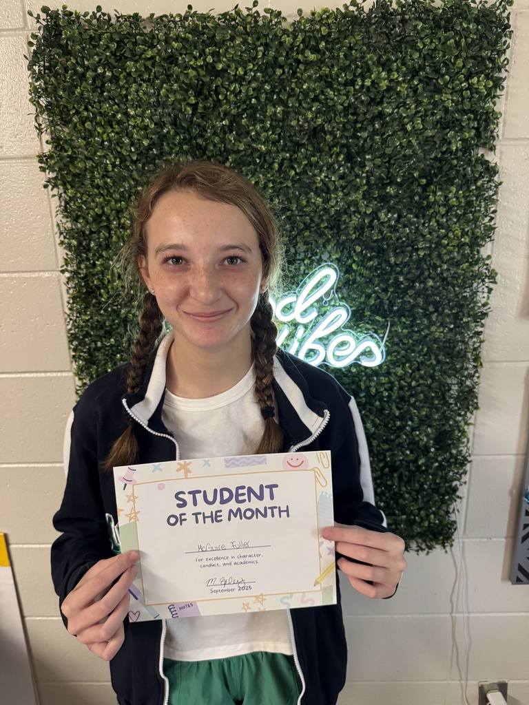 Student posing with certificate