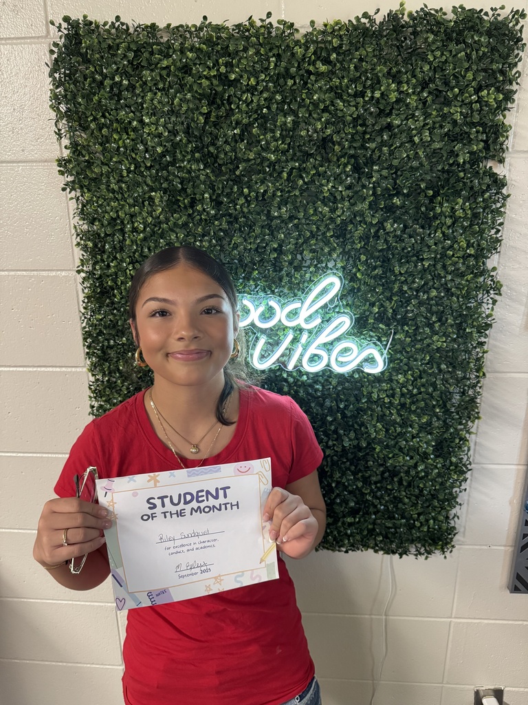 Student posing with certificate
