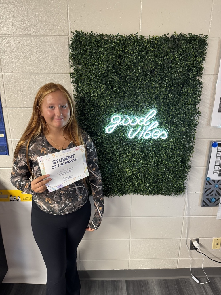 Student posing with certificate