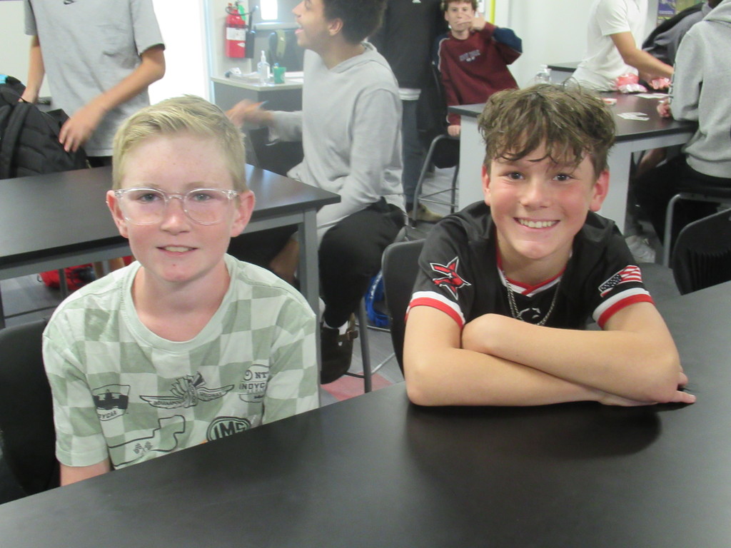 Two boys sitting in class together