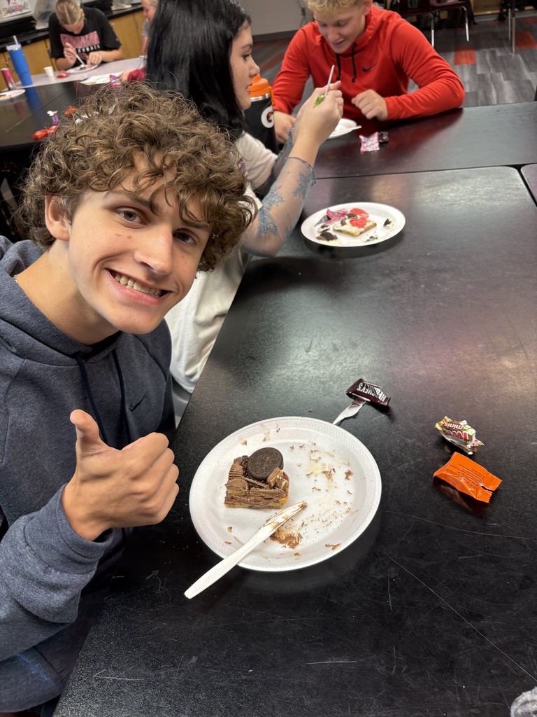 Student smiles with "cookie cell" he made.