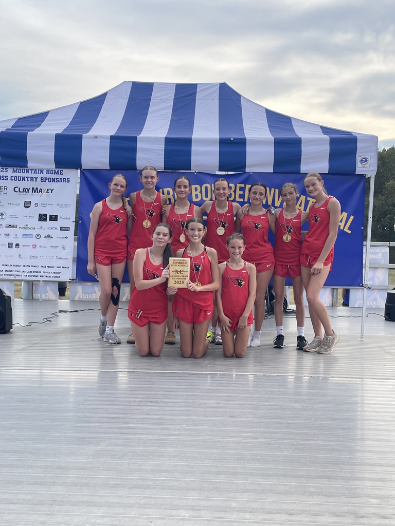 Jr girls XC team posing for a photo