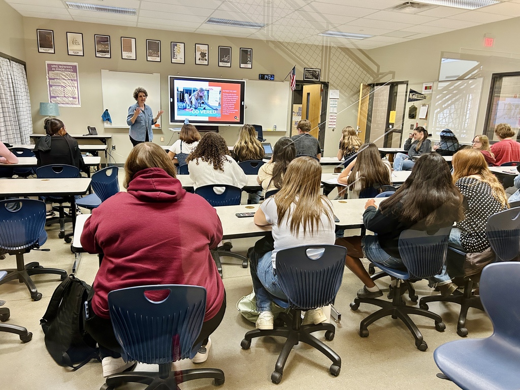 Yearbook students listening to a speaker