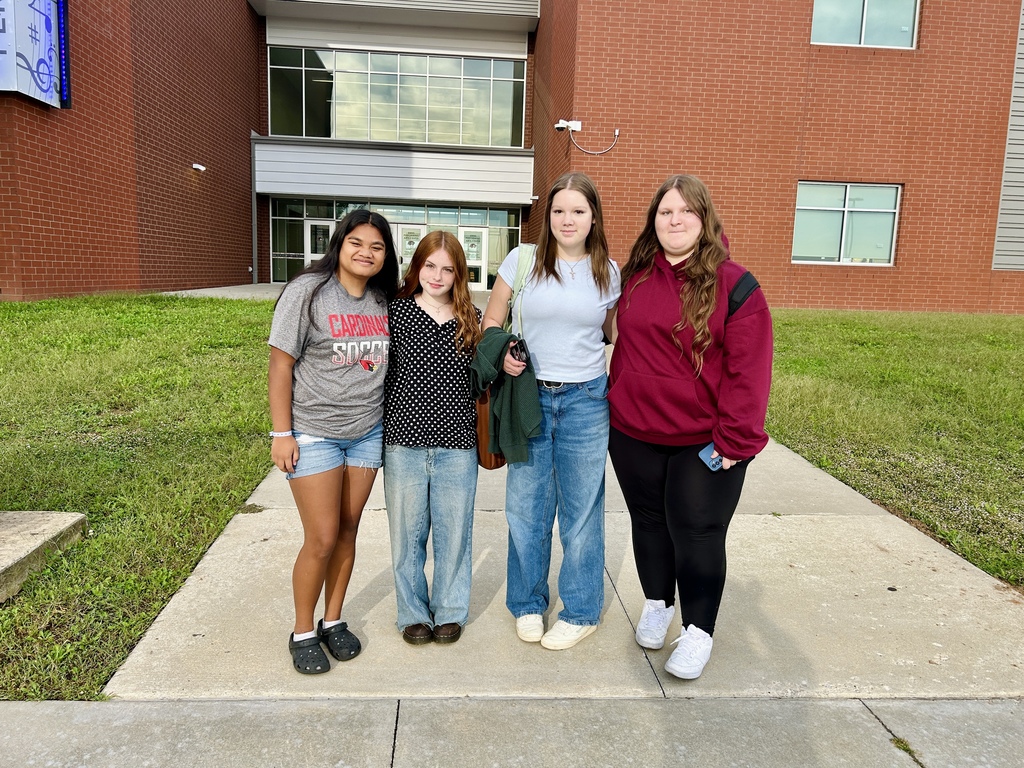 Yearbook editors standing in front of Bentonville West high school