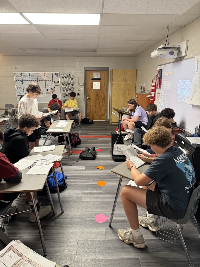 Students acting out a scene from a book in English class